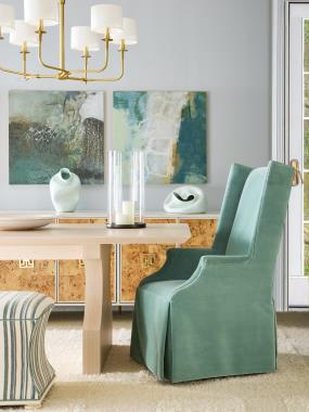 Room Scene:  HC240-70 Elio Dining Table shown in Sahara finish; HC4600-70C3 Textures Credenza with (F9) Mappa Burl door, (MSA) Metal Saber Leg Bracket Antique Brass, customers on hardware with Hardware (P1) Centered Placement shown in Weather White finish; HC151-03 Martin Dining Chair, Tight Seat, Waterfall Skirt shown in fabric PE6539-52 and HC329-29 Charles Hassock shown in fabric HC462-34 and  Antique Ivory finish.