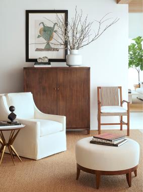 Room Scene: HC1545-70 Blackland Cabinet and HC1312-01 Aix-en-Provence Arm Chair shown in standard Light Walnut finish and in fabric HC2393-10, HC1535-27 Chatham Swivel Chair in fabric HC4150-10 with self fabric border and HC1385-70 Eden Side Table.